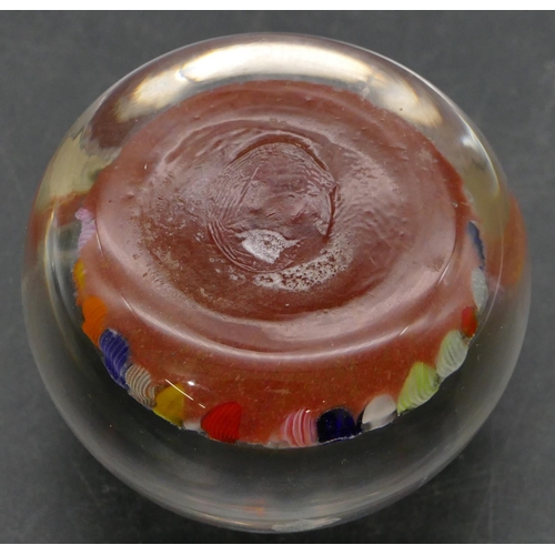 91 - A glass bulbous shaped millefiori paperweight with multi-coloured inner decoration, 6.5cm diameter.