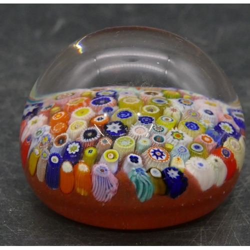 91 - A glass bulbous shaped millefiori paperweight with multi-coloured inner decoration, 6.5cm diameter.