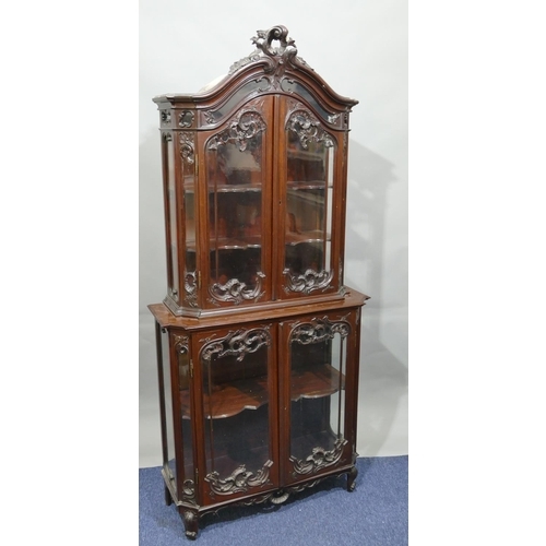 792 - An Edwardian mahogany display cabinet with allover carved raised scroll and leaf decoration, 2 glass... 