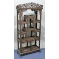 A 19th/20th Century Chinese carved hardwood open display cabinet with allover raised fruit, floral, ... 