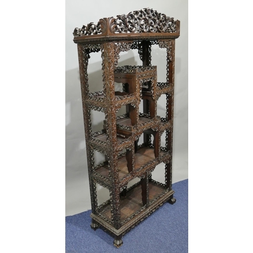 793 - A 19th/20th Century Chinese carved hardwood open display cabinet with allover raised fruit, floral, ... 