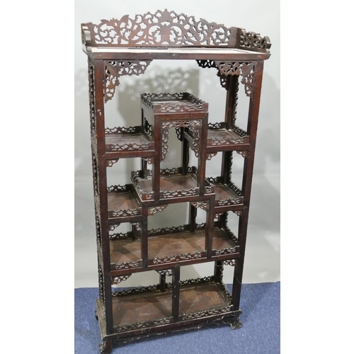 793 - A 19th/20th Century Chinese carved hardwood open display cabinet with allover raised fruit, floral, ... 