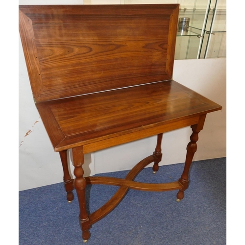 823 - A 20th Century rosewood tea table with hinged swivel top, on round turned legs and X-shaped stretche... 