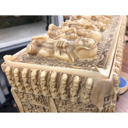 762 - A resin rectangular shaped box with cover, allover Oriental figure decoration, 30cm wide, 16cm high.