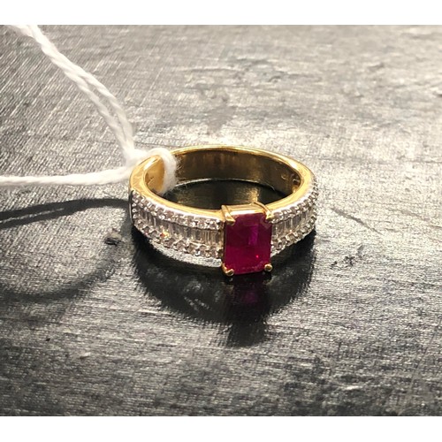 447 - An 18ct gold ladies ring set with centre ruby and flanked by various shaped diamonds, Size N, 5.9 gr... 