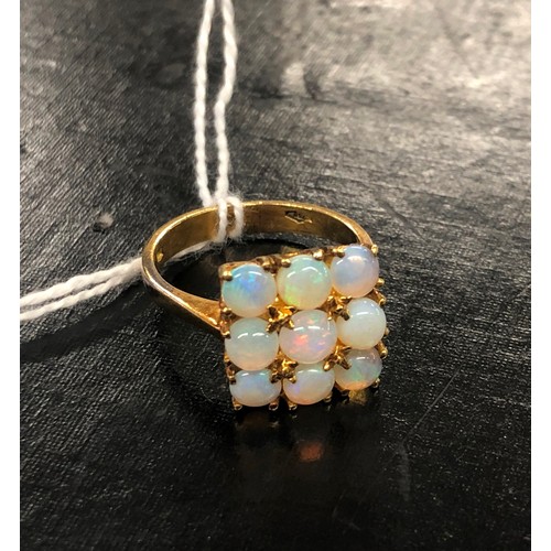 522 - An 18ct gold square ladies cluster ring set with 9 opals, size N/O, 5.2 grams gross.