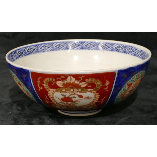 107 - An Imari round bowl on white, red and blue ground with floral, leaf and gilt decoration, 15.2cm diam... 