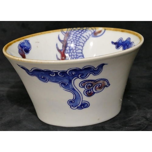 110 - A Chinese blue and white round trumpet shaped bowl with dragon and red decoration, labelled to base ... 