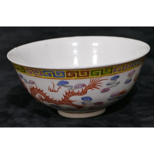 111 - A Chinese round trumpet shaped bowl on white ground with multi-coloured dragon and phoenix decoratio... 