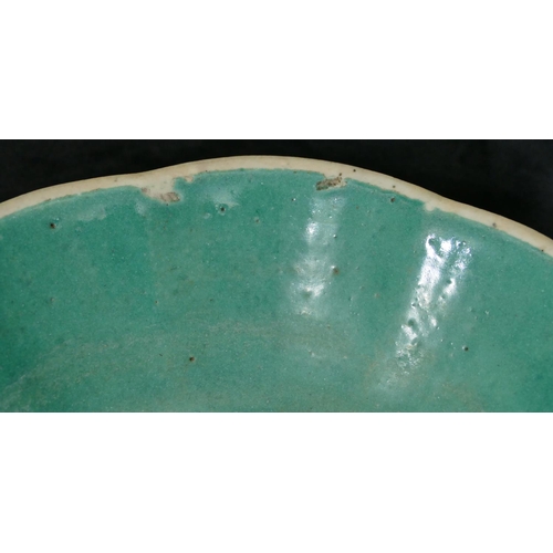 115 - An Oriental glazed round scallop shaped shallow bowl on yellow and green ground with fruit and scrol... 