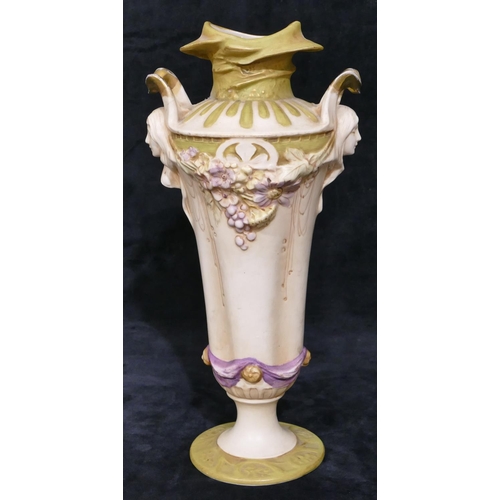 124 - A Royal Dux Art Nouveau round bulbous thin necked 2-handled vase with raised figureheads of ladies w... 