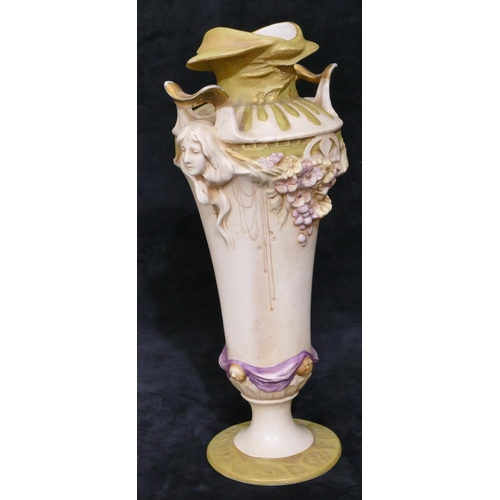 124 - A Royal Dux Art Nouveau round bulbous thin necked 2-handled vase with raised figureheads of ladies w... 