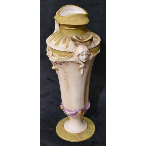 124 - A Royal Dux Art Nouveau round bulbous thin necked 2-handled vase with raised figureheads of ladies w... 