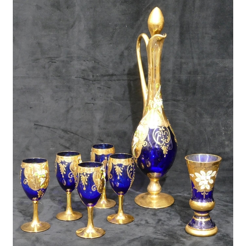 126 - A Viennese blue and gilt glass round bulbous tall jug with stopper, 5 matching glasses with raised f... 