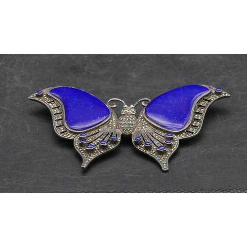 405 - A 925 silver and lapis lazuli brooch in the form of a butterfly, 10.5cm wide, 59.g grams gross