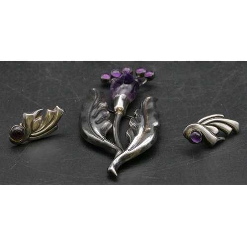 406 - A Mexican 925 silver and amethyst floral brooch, 10.5cm high, a pair of similar earrings (3)