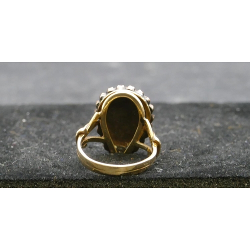 409 - A gold ladies cluster ring with centre pear shaped garnet, surround by smaller garnets, Size P, 6.3 ... 