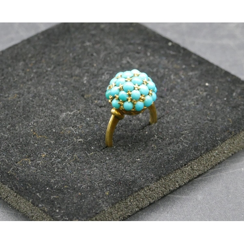 411 - An 18ct gold circular turquoise cluster ring, Size I/J, 6 grams gross