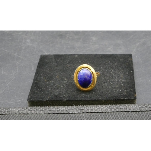 412 - An Eastern high carat gold oval ladies ring set with centre blue stone, Size U/V, 6.2 grams gross