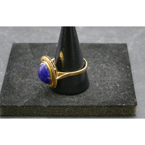 412 - An Eastern high carat gold oval ladies ring set with centre blue stone, Size U/V, 6.2 grams gross