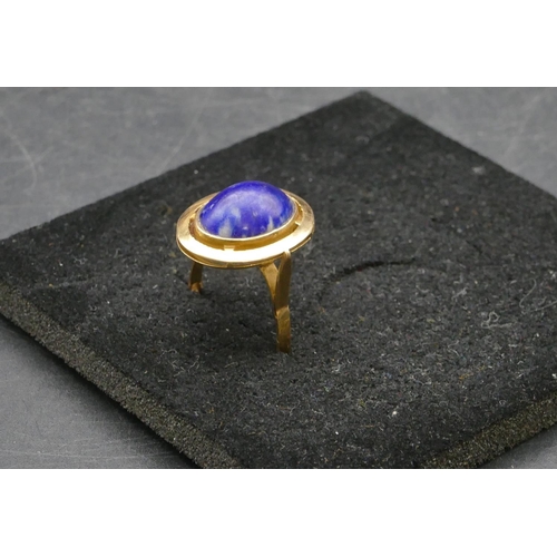 412 - An Eastern high carat gold oval ladies ring set with centre blue stone, Size U/V, 6.2 grams gross