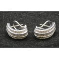 A pair of 18ct white gold half hoop earrings, each set with 22 baguette cut diamonds (estimated weig... 