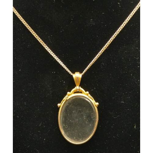 421 - A 9ct gold oval double-sided pendant with glass front and back, 9ct gold flat-linked chain, 46.5cm l... 