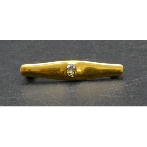 451 - A gold bar brooch set with centre diamond approx. 0.30ct, 4cm long, 5.2 grams gross.