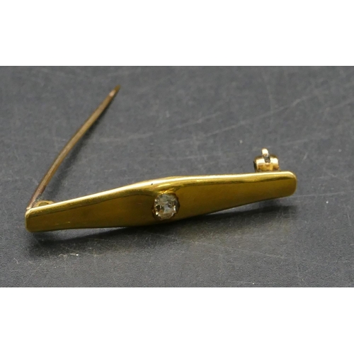 451 - A gold bar brooch set with centre diamond approx. 0.30ct, 4cm long, 5.2 grams gross.