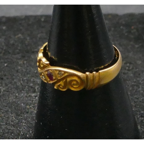 455 - An 18ct gold ring set with centre ruby and flanked by rough cut diamonds, size L/M, 2.4 grams gross.