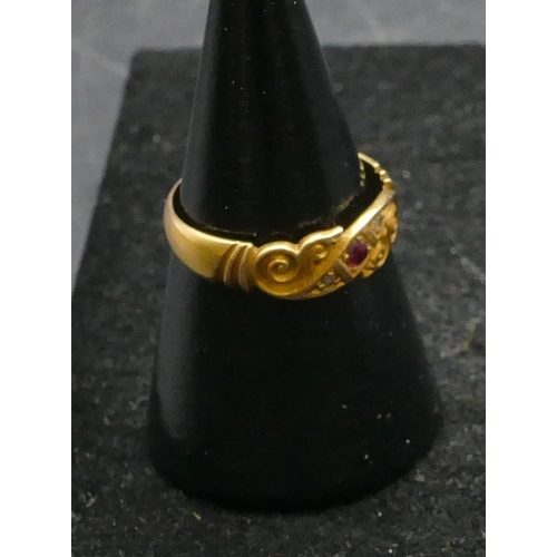 455 - An 18ct gold ring set with centre ruby and flanked by rough cut diamonds, size L/M, 2.4 grams gross.