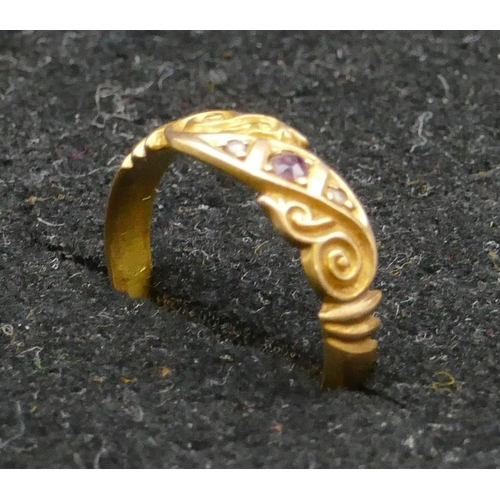 455 - An 18ct gold ring set with centre ruby and flanked by rough cut diamonds, size L/M, 2.4 grams gross.