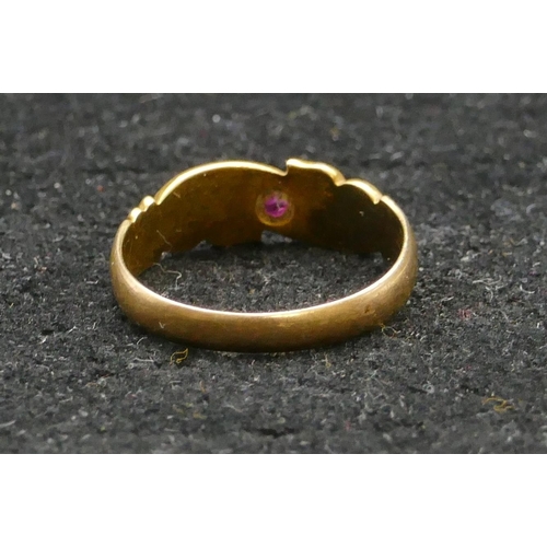 455 - An 18ct gold ring set with centre ruby and flanked by rough cut diamonds, size L/M, 2.4 grams gross.