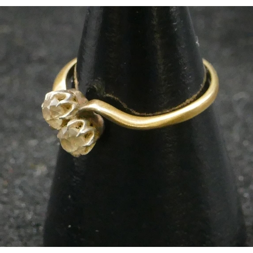 459 - An 18ct gold ladies twist diamond ring set with 2 diamonds, approx. 0.20ct each, size L/M, 2.1 grams... 