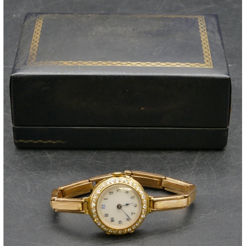 463 - An 18ct gold circular wristwatch with white enamel dial and Arabic numerals all surrounded by 34 dia... 