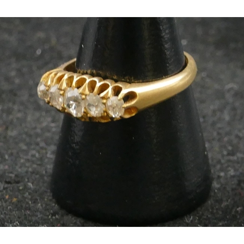 465 - An 18ct gold ladies 5-stone graduated diamond ring with pierced shoulders, centre diamond approx. 0.... 