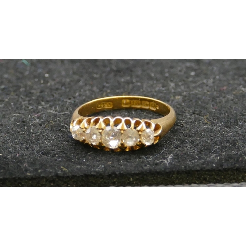 465 - An 18ct gold ladies 5-stone graduated diamond ring with pierced shoulders, centre diamond approx. 0.... 