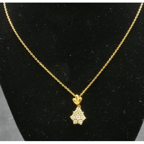 472 - A gold pendant mounted with white sapphires, with chain, 4.8 grams gross.