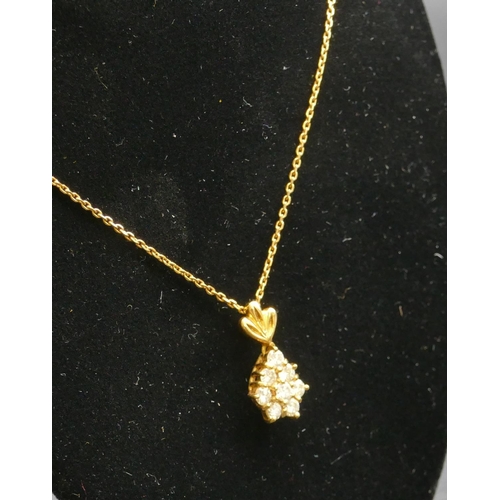 472 - A gold pendant mounted with white sapphires, with chain, 4.8 grams gross.