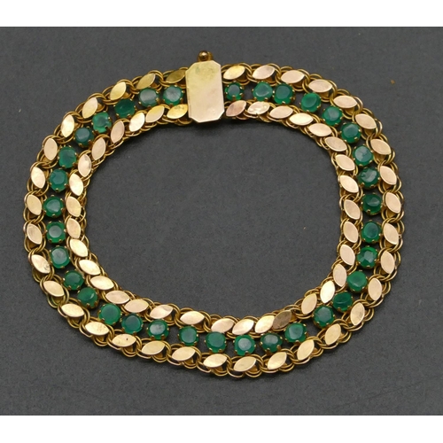 476 - A high ct gold flat linked bracelet mounted with emeralds, 17cm long, 8.8 grams gross.