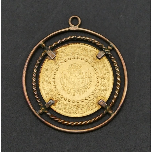 485 - An Eastern gold coin mounted in 9ct gold circular pendant, 5.4 grams gross.