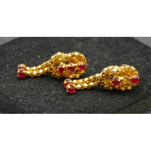 491 - A pair of Eastern high carat gold knot shaped earrings with drop tassels mounted with red stones (1 ... 