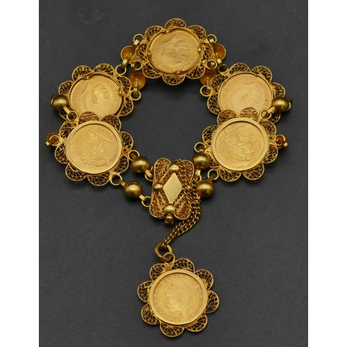 494 - An Eastern high carat gold bracelet mounted with 6 George V quarter sovereigns, 1922, overall weight... 