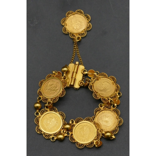 494 - An Eastern high carat gold bracelet mounted with 6 George V quarter sovereigns, 1922, overall weight... 