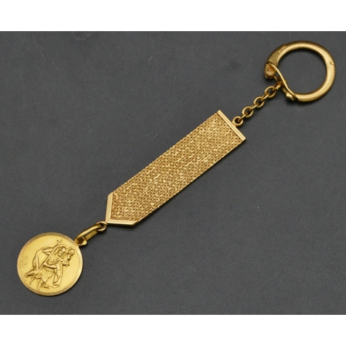 An 18ct gold keyring with chased decoration, mounted with 18ct gold St ...