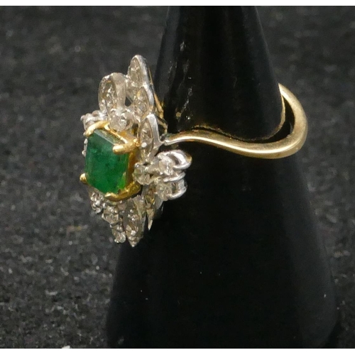 500 - A high carat yellow gold cluster ring set with centre emerald and surrounded by small diamonds, size... 