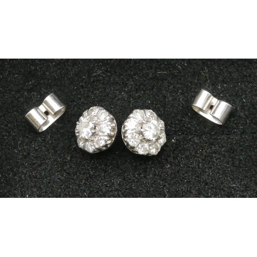 501 - A pair of platinum cluster earrings set with centre diamond (approx. 0.20ct) each surrounded by 8 sm... 