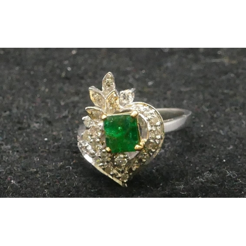 502 - A high carat white gold ladies cluster ring set with centre emerald and surrounded by diamonds, size... 