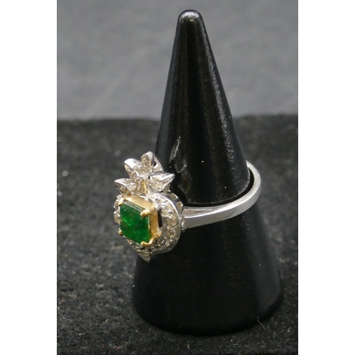 502 - A high carat white gold ladies cluster ring set with centre emerald and surrounded by diamonds, size... 