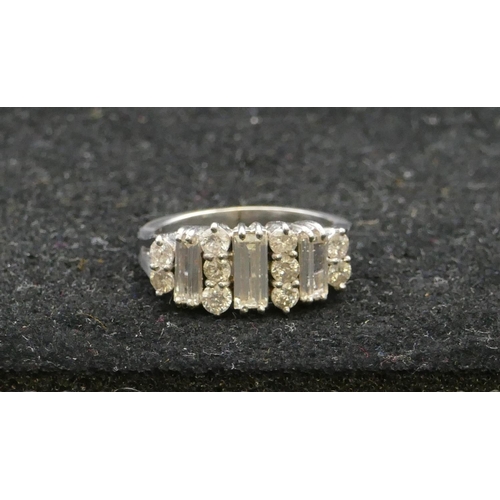 507 - A platinum ladies cluster ring set with 3 baguette diamonds interspersed with 10 further diamonds (c... 